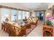 Airy living room with wicker furniture and large windows offers ample natural light and comfortable seating at 6037 Shearwater Dr, Englewood, FL 34224