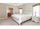 Serene bedroom with large windows, ceiling fan and en-suite bathroom provides relaxation and convenience at 6037 Shearwater Dr, Englewood, FL 34224