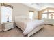 Bright primary bedroom with ample natural light, ceiling fan, and plush carpeting for a comfortable and serene retreat at 6037 Shearwater Dr, Englewood, FL 34224