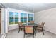 Enclosed patio overlooking water, complete with dining set to enjoy beautiful water views at 6037 Shearwater Dr, Englewood, FL 34224