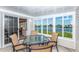 Enclosed patio with outdoor seating and waterfront views, ideal for relaxing and entertaining guests at 6037 Shearwater Dr, Englewood, FL 34224