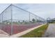 View of fenced-in community tennis and basketball court with benches and equipment at 6037 Shearwater Dr, Englewood, FL 34224