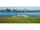 View of the lake and a community dock from the home's backyard at 6037 Shearwater Dr, Englewood, FL 34224