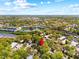Expansive aerial view of a home nestled among lush greenery, near a lake, and other residential areas at 614 N Jefferson Ave # 27, Sarasota, FL 34237