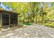 Relaxing backyard area with stone ground cover, outdoor seating, and lush tropical landscaping at 614 N Jefferson Ave # 27, Sarasota, FL 34237