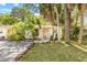 Charming single-story home with well-manicured lawn, mature tropical foliage, and inviting front entrance at 614 N Jefferson Ave # 27, Sarasota, FL 34237