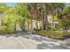 Charming single-story home with well-manicured lawn, mature tropical foliage, and inviting front entrance at 614 N Jefferson Ave # 27, Sarasota, FL 34237