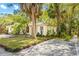 Charming single-story home features a well-maintained lawn, lush landscaping and a paved driveway at 614 N Jefferson Ave # 27, Sarasota, FL 34237