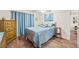 Main bedroom with a cozy ambiance, featuring ample natural light and a decorative painting at 614 N Jefferson Ave # 27, Sarasota, FL 34237