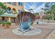 Downtown sculpture of a shell on a brick-paved intersection with restaurants and storefronts in the background at 614 N Jefferson Ave # 27, Sarasota, FL 34237