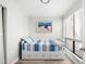 Bright bedroom featuring a daybed with striped bedding and a sunny window at 6157 Midnight Pass Rd # D31, Sarasota, FL 34242