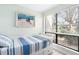 Bright bedroom featuring a daybed with striped bedding and a sunny window at 6157 Midnight Pass Rd # D31, Sarasota, FL 34242