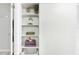 Linen closet with organized shelves and decorative items at 6157 Midnight Pass Rd # D31, Sarasota, FL 34242