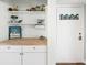 The entrance to the home features a white door, storage and countertop at 6157 Midnight Pass Rd # D31, Sarasota, FL 34242