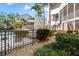 Well-maintained exterior with tropical landscaping and community pool view at 6157 Midnight Pass Rd # D31, Sarasota, FL 34242
