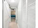Hallway view showcasing the hallway and partial bedroom with wood accent wall at 6157 Midnight Pass Rd # D31, Sarasota, FL 34242