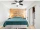 Bedroom with wood accent wall, ceiling fan, and closet at 6157 Midnight Pass Rd # D31, Sarasota, FL 34242