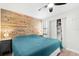 Bedroom with wood accent wall, ceiling fan, and closet at 6157 Midnight Pass Rd # D31, Sarasota, FL 34242