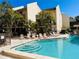 Community pool area with lounge chairs surrounded by lush landscaping at 6157 Midnight Pass Rd # D31, Sarasota, FL 34242