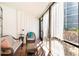 Cozy sunroom with wicker furniture, tiled floor, and sheer curtains at 6157 Midnight Pass Rd # D31, Sarasota, FL 34242