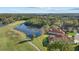 Aerial view of a single-Gathering home overlooking a golf course and lake at 6210 Cormorant Ct, Bradenton, FL 34203