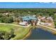 Stunning aerial view of the clubhouse with pond and golf carts parked nearby at 6210 Cormorant Ct, Bradenton, FL 34203