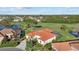 Aerial view of a single-Gathering home with a red tile roof and screened-in pool at 6210 Cormorant Ct, Bradenton, FL 34203