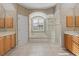 Elegant bathroom with double sinks, soaking tub, separate shower, and plantation shutters at 6210 Cormorant Ct, Bradenton, FL 34203