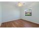 Cozy bedroom featuring hardwood floors, a ceiling fan, and a bright window view at 6210 Cormorant Ct, Bradenton, FL 34203