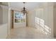 Elegant dining room offers tile floors, decorative chandelier, and a sunlit window with plantation shutters at 6210 Cormorant Ct, Bradenton, FL 34203