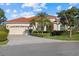 Charming single-story home features a tile roof, mature landscaping, and a two-car garage at 6210 Cormorant Ct, Bradenton, FL 34203