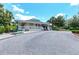 Beautiful exterior view of the clubhouse with a covered porch at 6210 Cormorant Ct, Bradenton, FL 34203