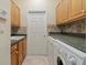Functional laundry room with upper cabinets, sink, and a washer and dryer at 6210 Cormorant Ct, Bradenton, FL 34203