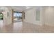 Spacious living area with tile floors and sliding glass doors that lead to the outdoor patio and pool at 6210 Cormorant Ct, Bradenton, FL 34203