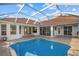 Backyard pool with brick trim and multiple sliding glass door access to the residence at 6210 Cormorant Ct, Bradenton, FL 34203