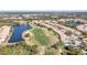 Beautiful aerial view of homes surrounding a golf course and pond in a Primary-planned community at 651 Back Nine Dr, Venice, FL 34285