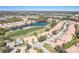 Scenic aerial view of a residential community, lush greenery, and a beautiful blue lake at 651 Back Nine Dr, Venice, FL 34285