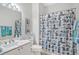 Bright bathroom with a shower/tub combo with nautical themed shower curtain at 651 Back Nine Dr, Venice, FL 34285