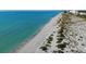 Picturesque beach view featuring sandy dunes, light blue ocean water and beachfront property at 651 Back Nine Dr, Venice, FL 34285
