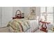 Bright bedroom with a floral quilt, wood dresser and bright light from the windows at 651 Back Nine Dr, Venice, FL 34285