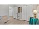 Bright bedroom features a closet and doorway to the hallway and light colored laminate flooring at 651 Back Nine Dr, Venice, FL 34285