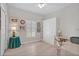 Bright bedroom with a Murphy bed, desk, ceiling fan, and bright light from the windows at 651 Back Nine Dr, Venice, FL 34285