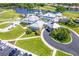 Aerial view of a large community center, parking, and golf course at 651 Back Nine Dr, Venice, FL 34285