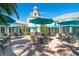 Charming courtyard with outdoor seating under umbrellas, creating a welcoming space for socializing and enjoying the weather at 651 Back Nine Dr, Venice, FL 34285