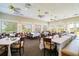 Bright dining room with multiple tables and chairs, perfect for hosting large gatherings or enjoying a meal with Gathering at 651 Back Nine Dr, Venice, FL 34285