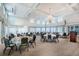 Spacious event room with elegant lighting and neatly arranged tables and chairs at 651 Back Nine Dr, Venice, FL 34285