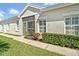 Single-story home with a tile roof, and manicured hedges along a well-maintained lawn and sidewalk at 651 Back Nine Dr, Venice, FL 34285