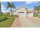 Charming single-story home with a 2-car garage, tile roof, and well-manicured landscaping at 651 Back Nine Dr, Venice, FL 34285