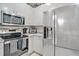 Updated kitchen with stainless steel appliances and light gray cabinets at 651 Back Nine Dr, Venice, FL 34285