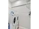 Laundry room features white washer, dryer, and metal shelving at 651 Back Nine Dr, Venice, FL 34285